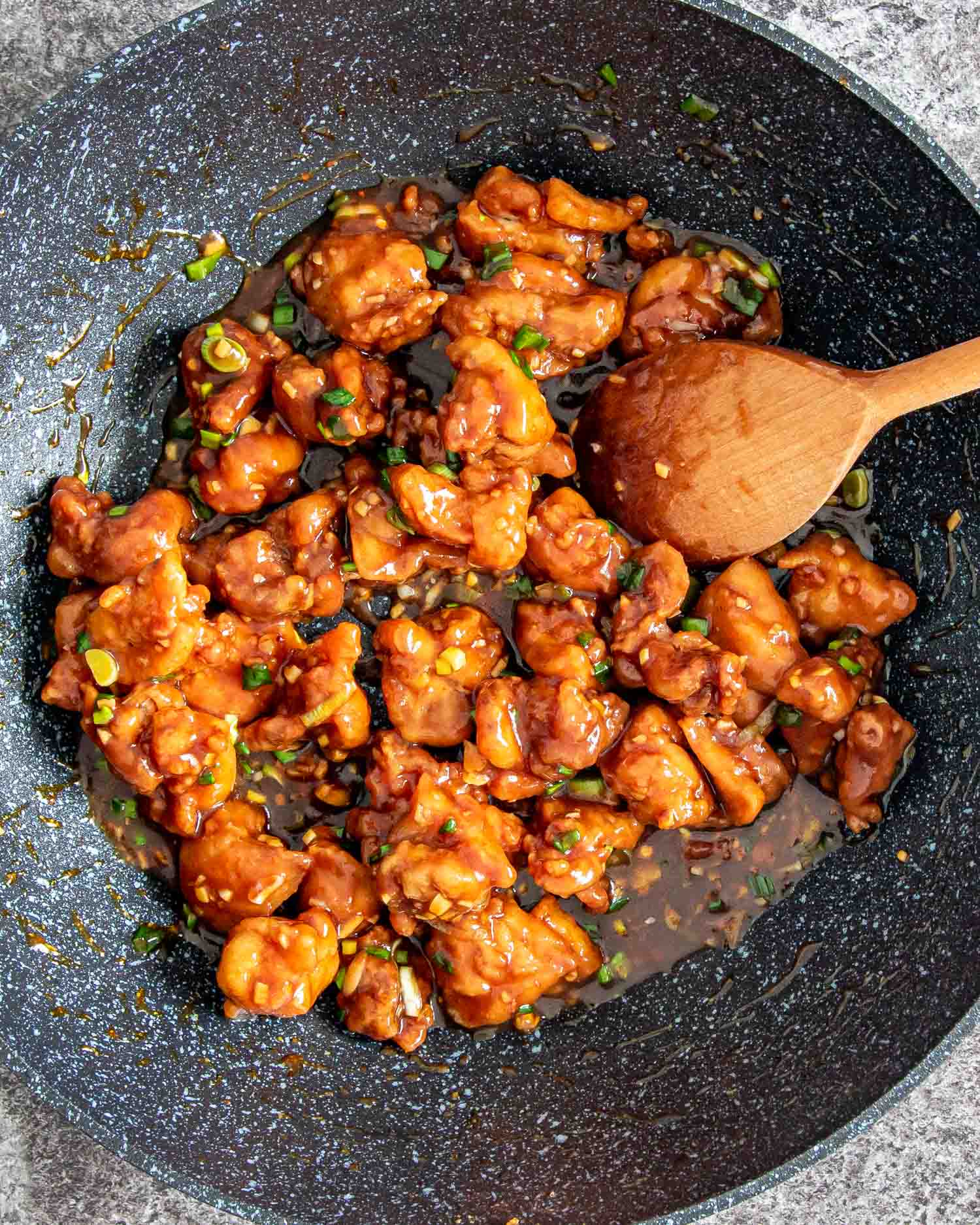 freshly made general tso's chicken in a wok.