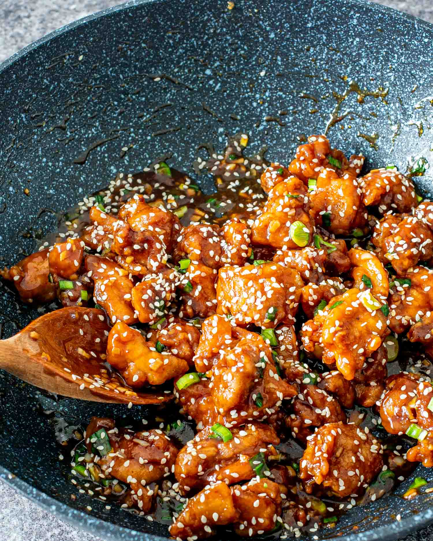 freshly made general tso's chicken in a wok.