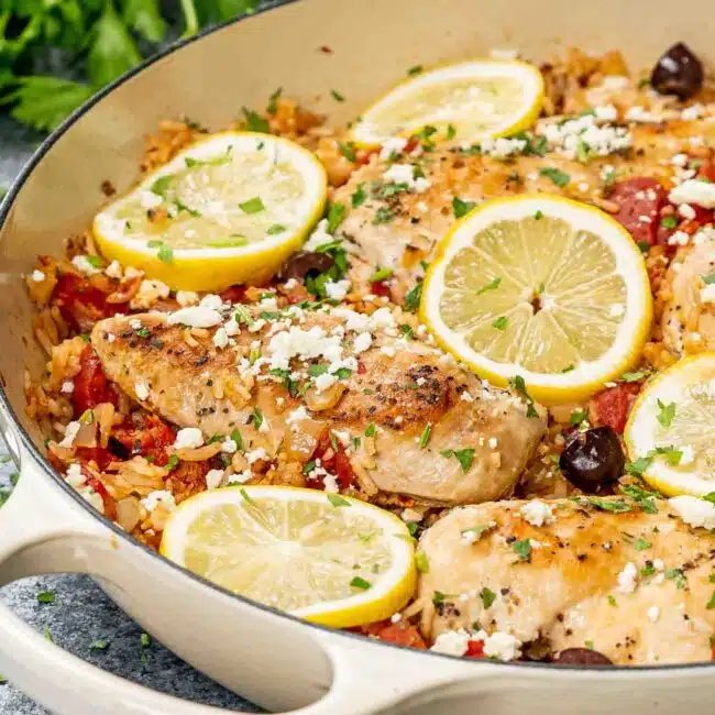 freshly made mediterranean chicken and rice in a skillet.