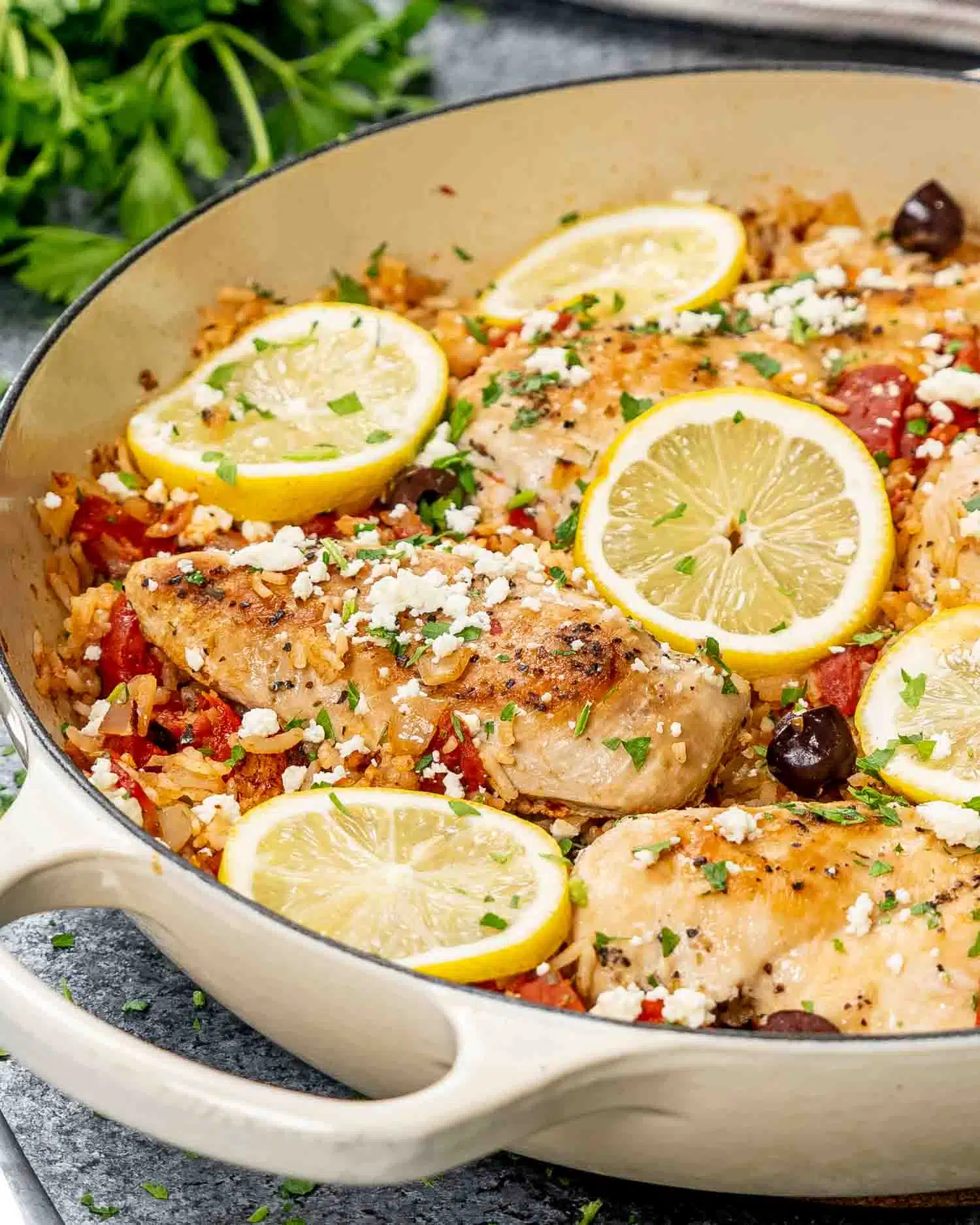 freshly made mediterranean chicken and rice in a skillet.