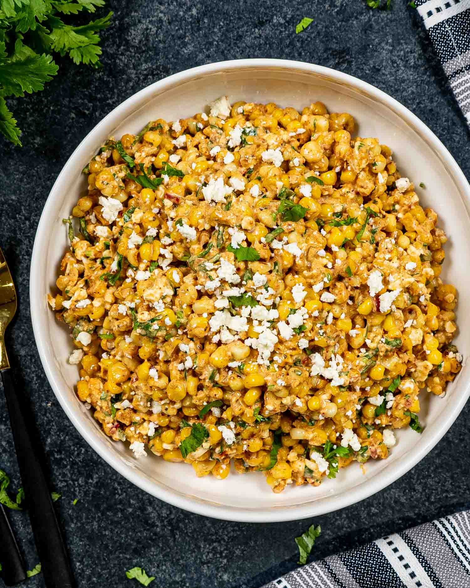 freshly made (mexican street corn salad in a white bowl.