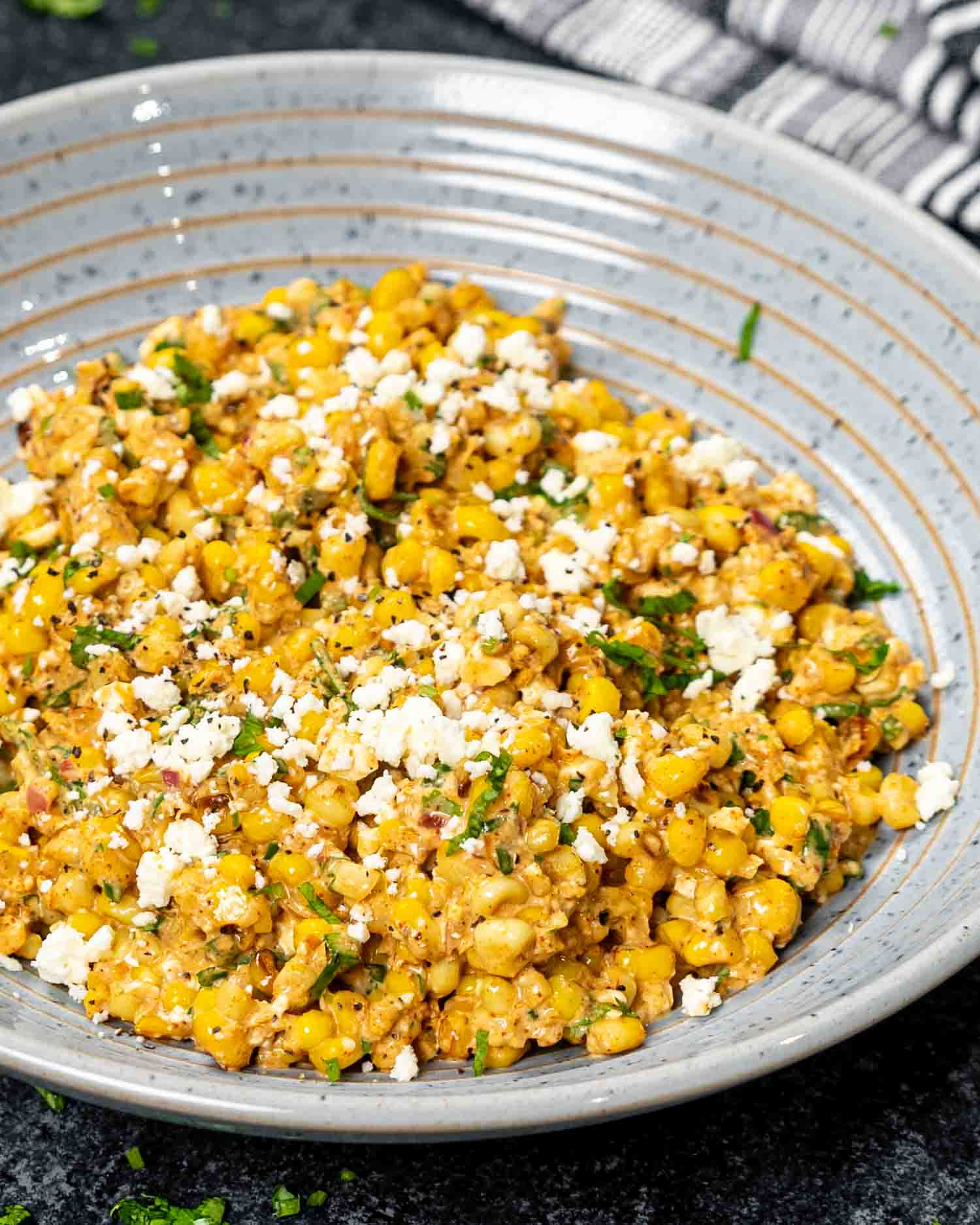 freshly made (mexican street corn salad in a blue bowl.