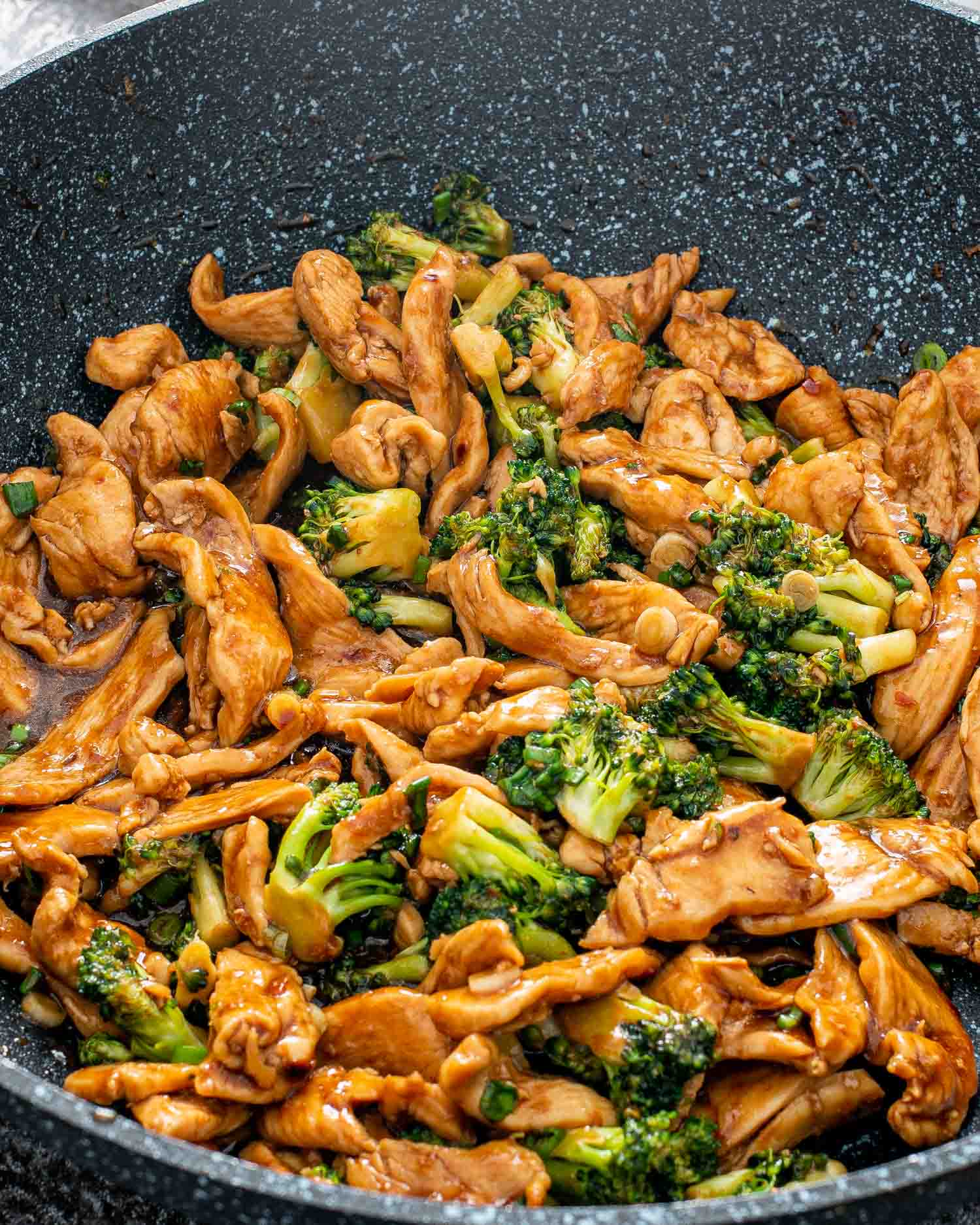 freshly made asian style chicken and broccoli in a wok.
