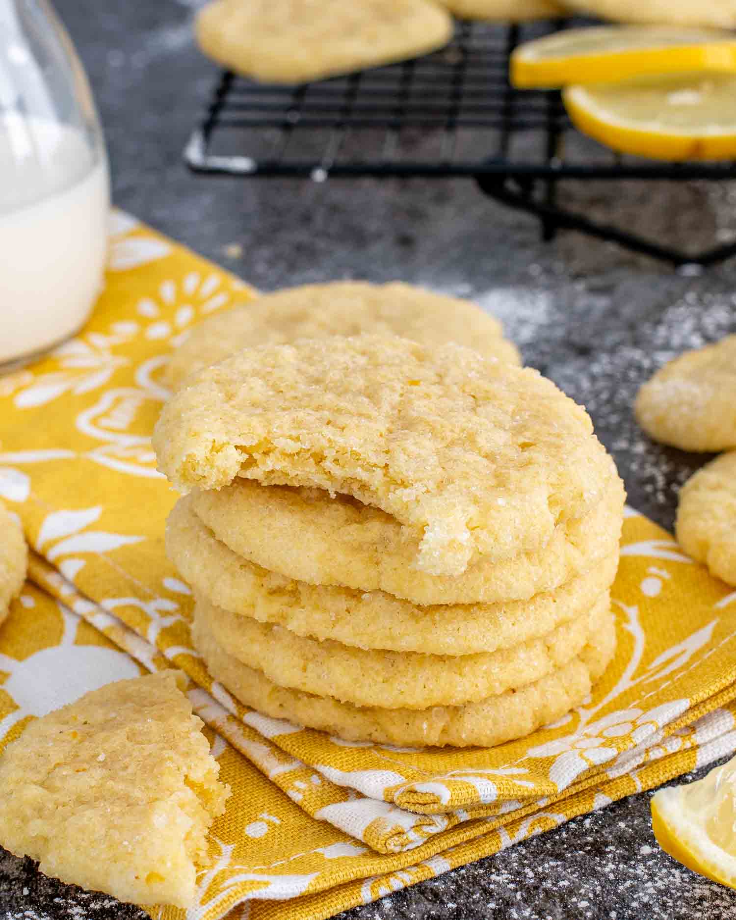 a stack of freshly baked lemon sugar cookies on a napkin.