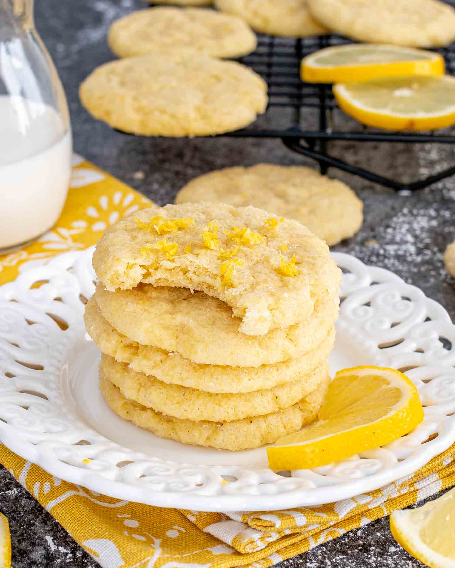 a stack of lemon sugar cookies on a white plate.