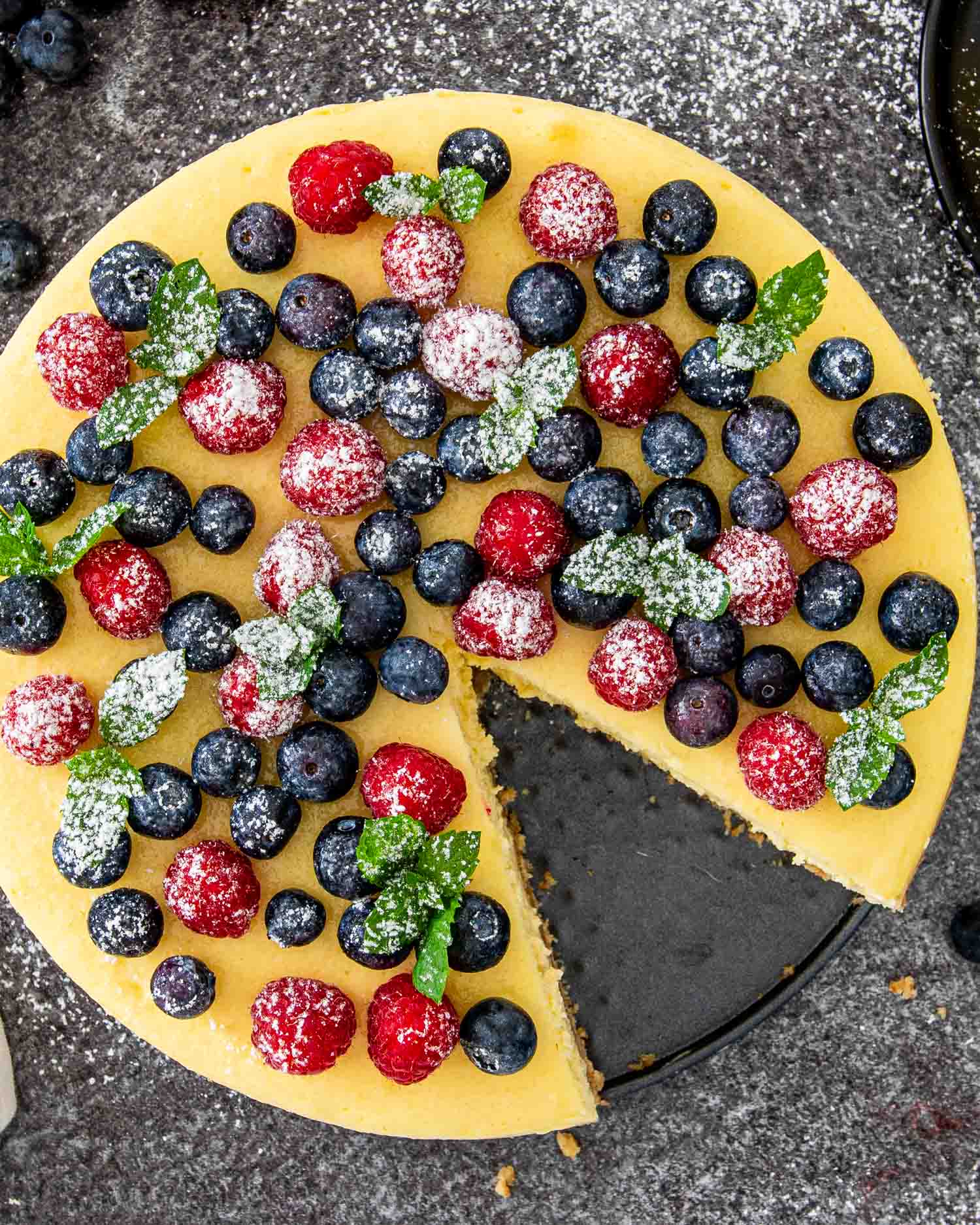 a gorgeous new york style cheesecake topped with berries.