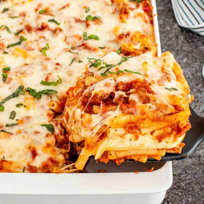 freshly made baked ziti in a white casserole dish.