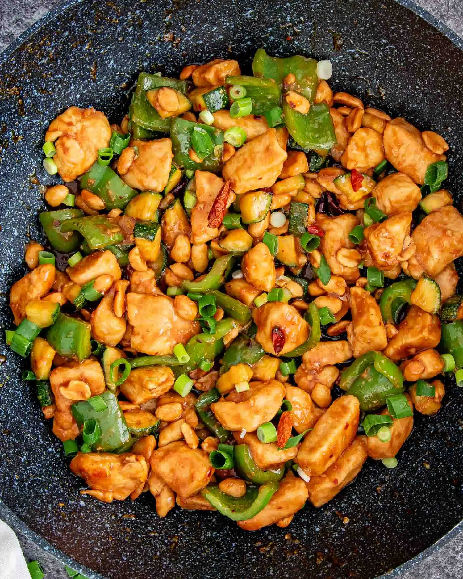 freshly made kung pao chicken in a wok.