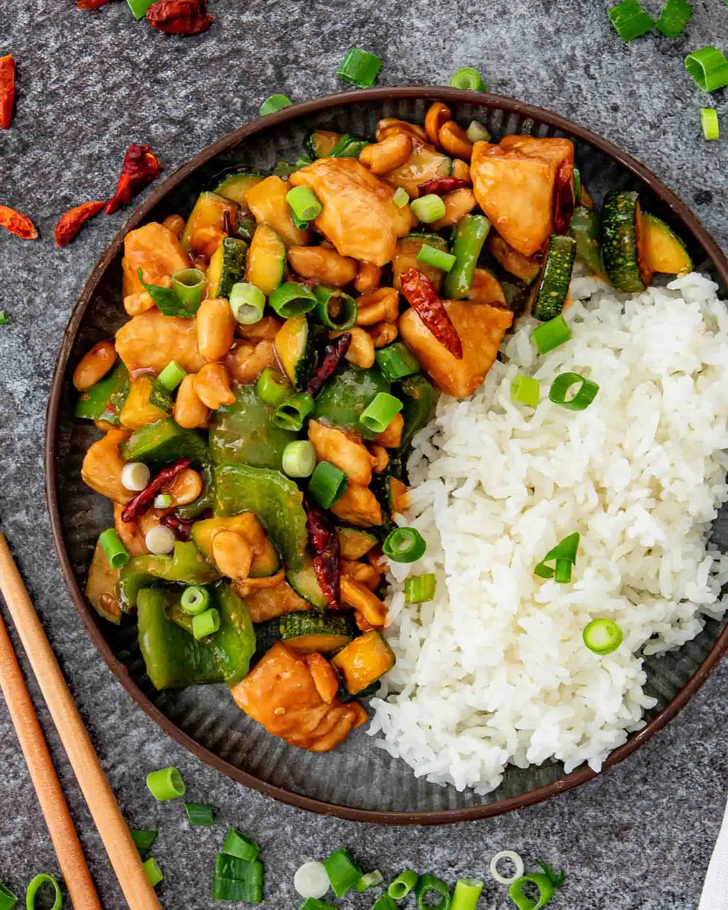 kung pao chicken with rice on a metal plate.