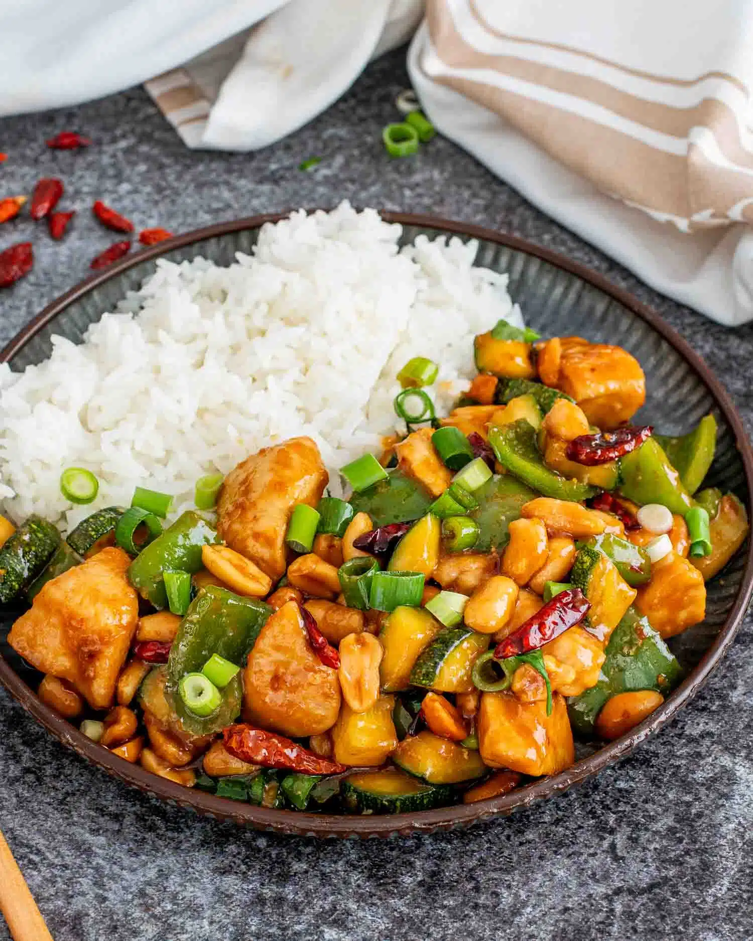 kung pao chicken with rice on a metal plate.
