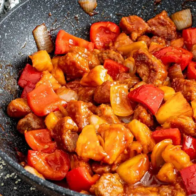freshly made sweet and sour pork in a wok.