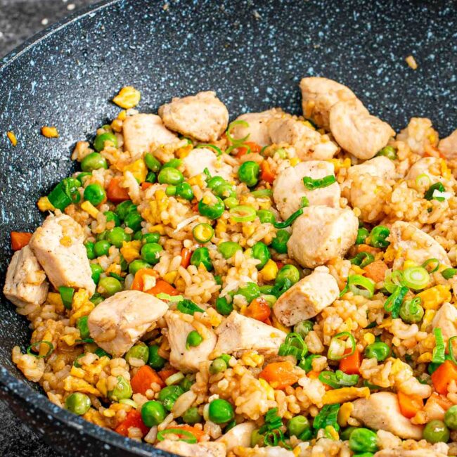 freshly made chicken fried rice in a wok.