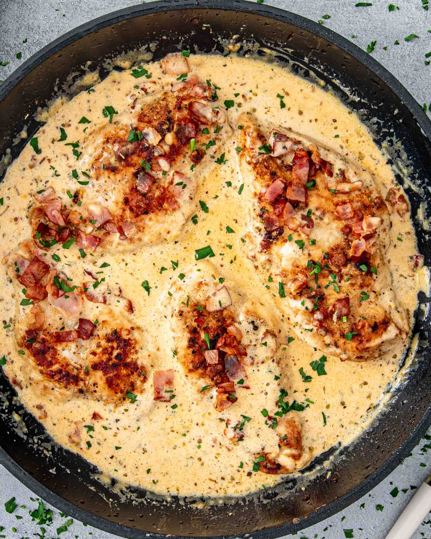 freshly made creamy bacon chicken in a skillet.