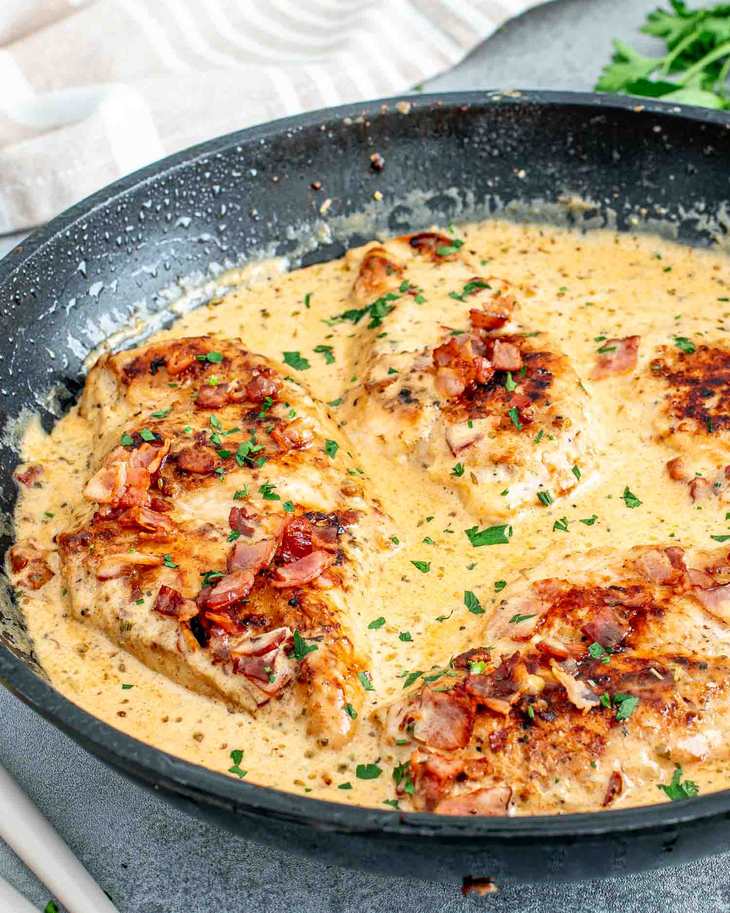 freshly made creamy bacon chicken in a skillet.