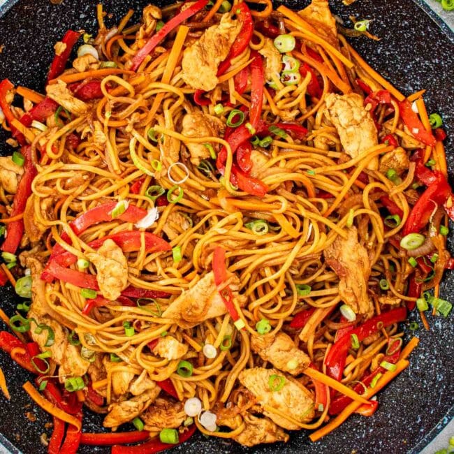 freshly made lo mein in a wok.