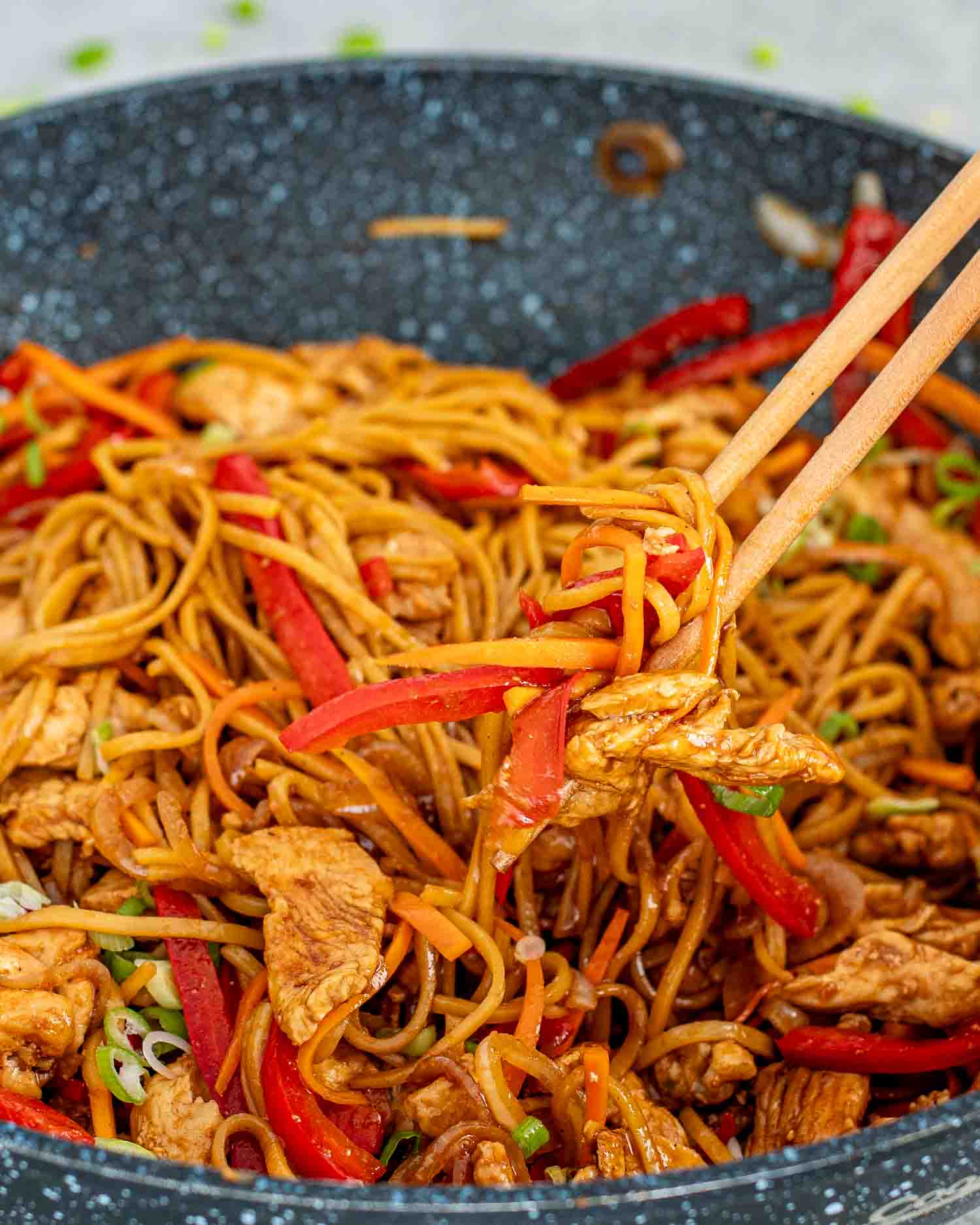 freshly made lo mein in a wok.