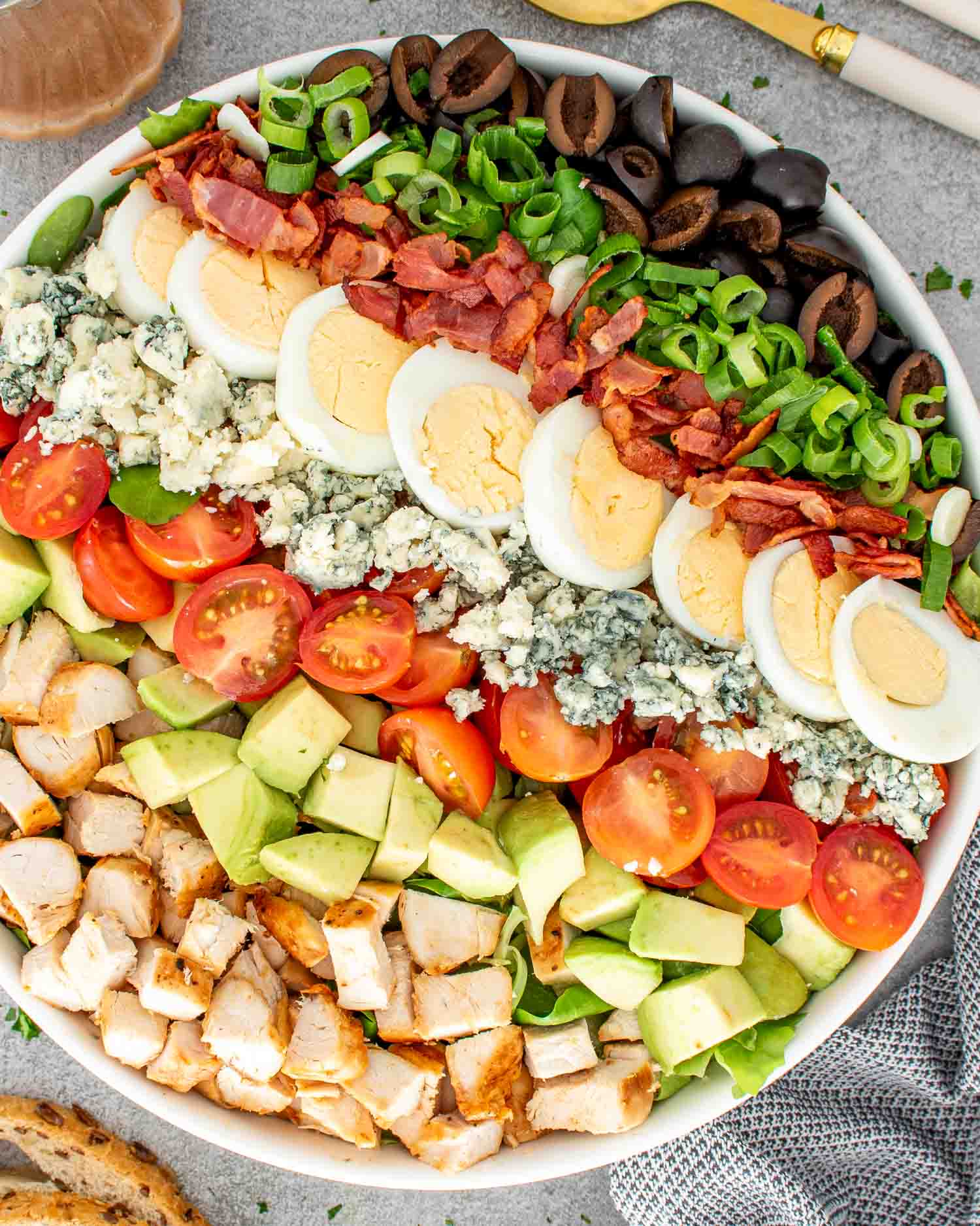 A fresh and colorful Cobb salad arranged beautifully in a bowl.