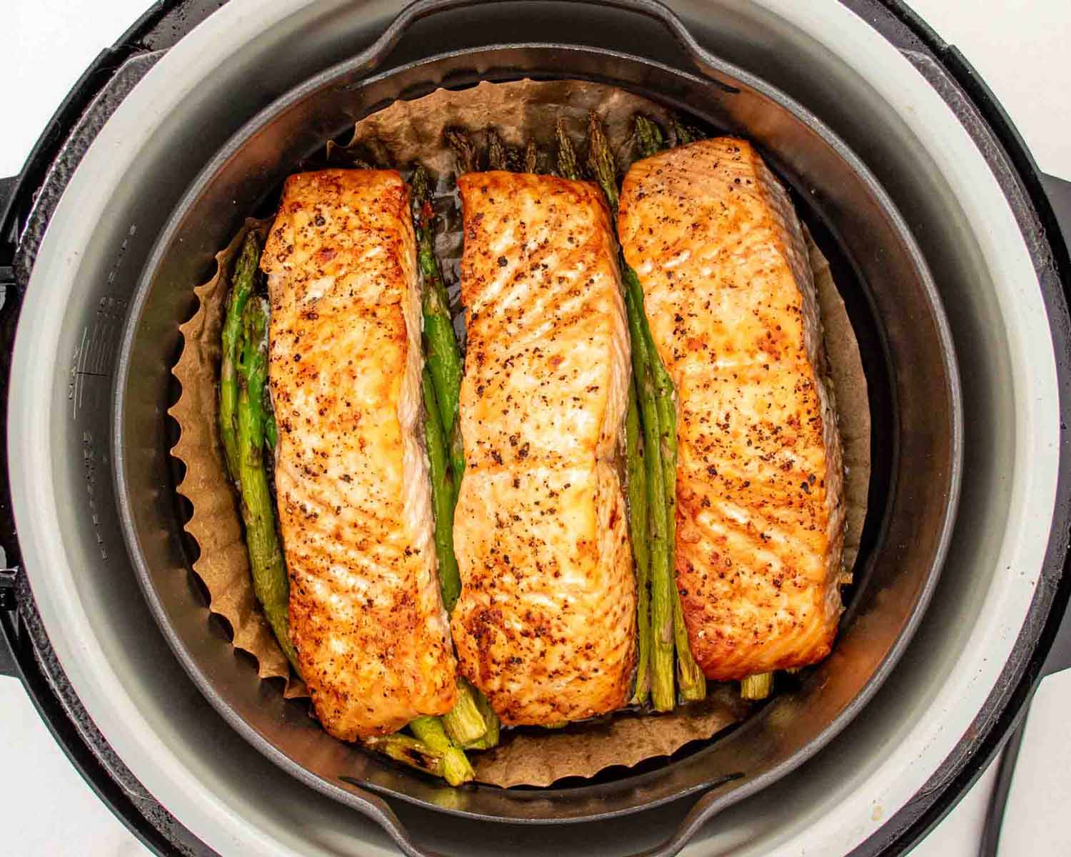 process shots showing how to make air fryer salmon and asparagus.