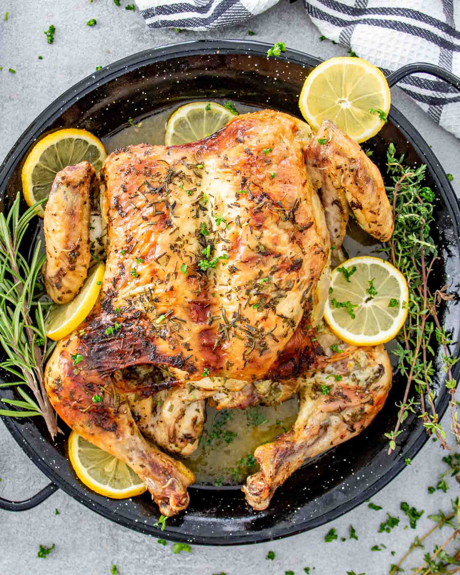 fresh out of the oven lemon garlic spatchcock chicken in a skillet.