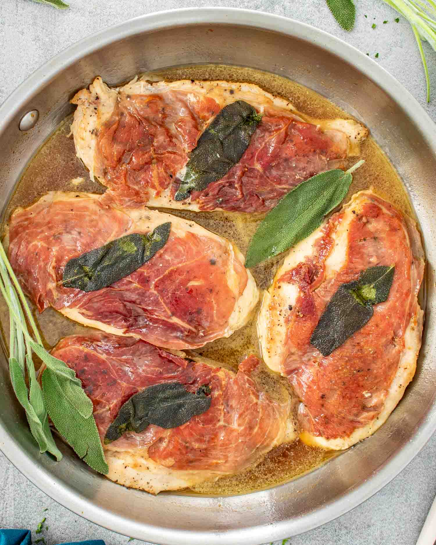 freshly made chicken saltimbocca in a skillet.
