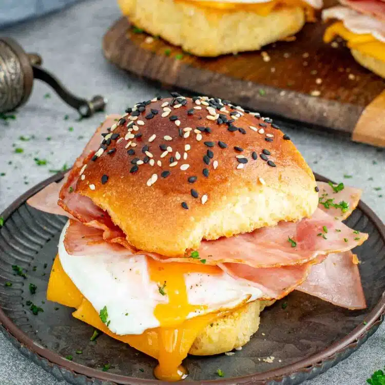 a breakfast sandwich on a metal plate.