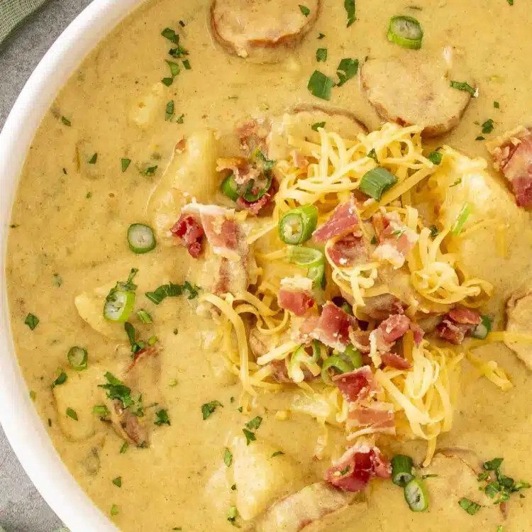 a white bowl loaded with cajun potato soup.