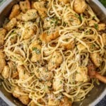 Chicken scampi cooked in a large skillet with golden chicken, linguine, Parmesan cheese, and garlic lemon butter sauce.