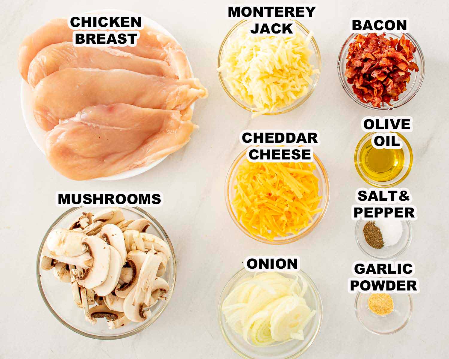 Ingredients for Texas Roadhouse smothered chicken including chicken breasts, mushrooms, onions, cheeses, bacon, olive oil, and seasonings.
