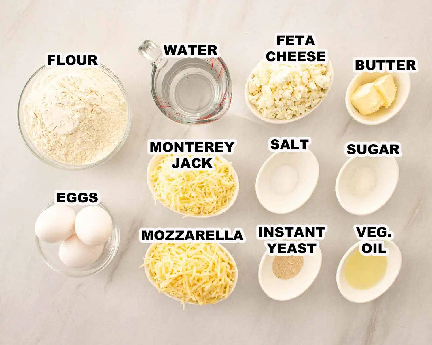 Ingredients for Khachapuri including flour, water, yeast, mozzarella, feta, Monterey Jack, eggs, butter, sugar, salt, and oil.