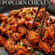 Pinterest graphic featuring glossy Korean popcorn chicken with sesame seeds, green onions, chopsticks, and an elegant recipe title.