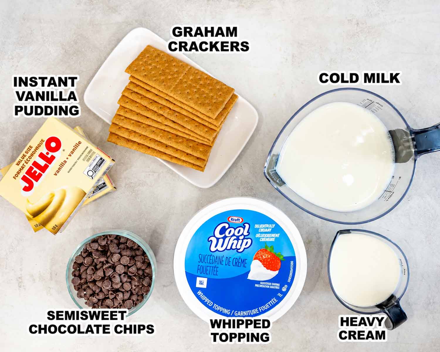 Labeled ingredients for no bake chocolate eclair cake include pudding mix, graham crackers, milk, whipped topping, chocolate chips, and cream.